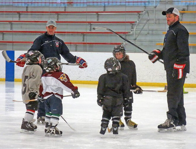 Coaches Ken Mangini and Adam Duskocy working with mini-mites.