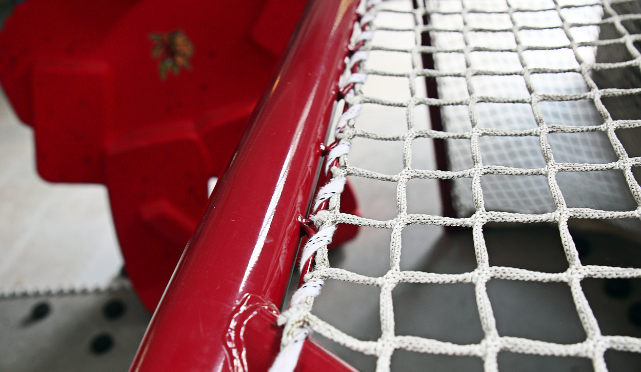 Stringing the net with skate laces.